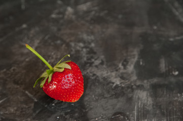Fresh strawberries closeup. Ripe strawberries on a dark background and copy space.