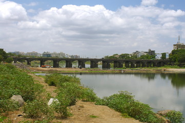 Fototapeta na wymiar View of the old Bund Garden Bridge (formerly Fitzgerald Bridge), Yerwada, Pune, Maharashtra, INDIA. HORIZONTAL IMAGE