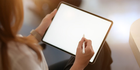 Cropped shot of young businesswoman working with blank screen laptop computer