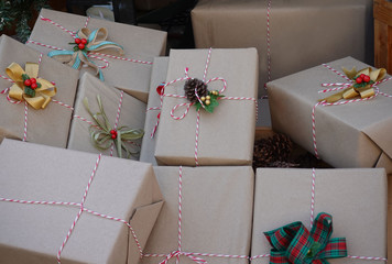 Happy holiday of Gift box wrapped in recycled paper with ribbon bow