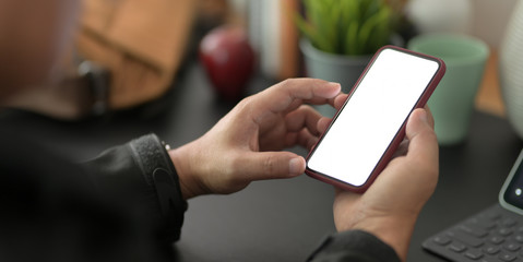 Cropped shot of young businessman using blank screen smartphone