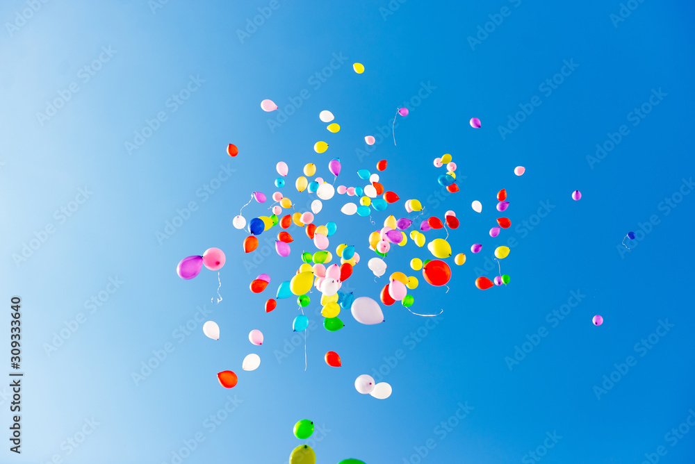 Wall mural inflatable balloons in the sky released into the sky at graduation in school kindergarten. multicolo
