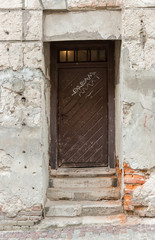 Old dark brown wooden front door with diagonal lines