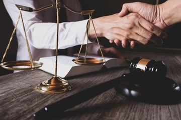 Close-up of male lawyer shaking hands