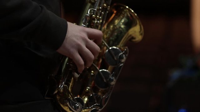 beautiful saxophone playing, guy’s hands playing saxophone
