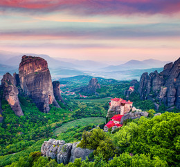 Fototapeta na wymiar Great summer view of Eastern Orthodox monasteries listed as a World Heritage site, built on top of rock pillars. Splendid sunset in Kalabaka, Greece, Europe. Traveling concept background.