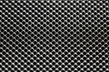 Black bumpy rubber surface used as a background. Black and white texture of rubber material with...