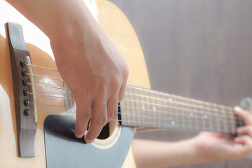 Acoustic Guitar Playing. Men Playing Acoustic Guitar Closeup Photography.