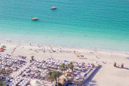 Background Top View Of The Beautiful Snow-white Beach And The Emerald Water Of The Persian Gulf In Dubai Marina, Dubai, UAE