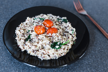 vegan coconut rice with spinach and cherry tomatoes