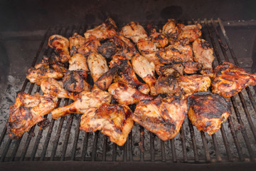 Grilling chicken wings and legs. BBQ, picnic, relaxation