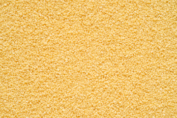 Pile of uncooked Couscous, closeup top view