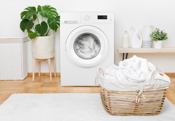 Laundry in washing machine and basket, interior of pastel colors - obrazy, fototapety, plakaty