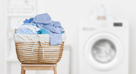 Laundry basket on blurred background of modern washing machine - obrazy, fototapety, plakaty