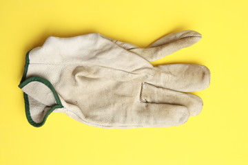 used leather work gloves in color background