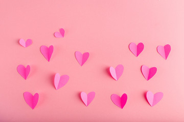 background with pink hearts made of paper