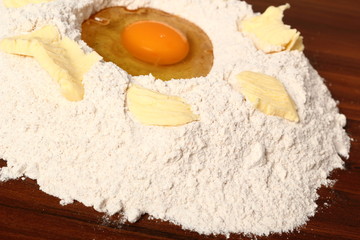 Pile of flour, egg and butter. Making Christmas Gingerbread Cookies