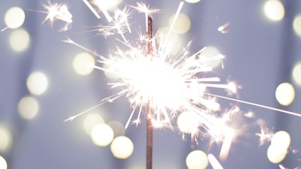 Close-up of firework sparkler burning. Fireworks burn on a blue background