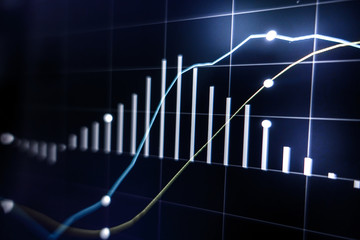 Stock market graph on laptop screen for business or economic concept.
