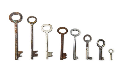 Background of assorted old multi-colored metal antique keys of different shapes. Home security concept.
