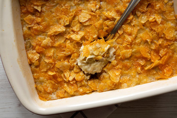 Cheesy Homemade Funeral Potatoes Casserole in a dish, top view. Flat lay, overhead, from above....