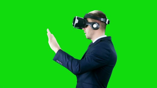 Business Man Uses Virtual Reality Glasses Over Chroma Key Green Screen, Smiling Businessman Touch Virtual Interface Modern Visual Technology