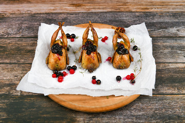 quail on a wooden background. On a wooden background. Little turkey. Close-up. Three quails. Small...