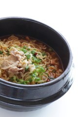 Pork and Korean spicy ramen noodles in traditional clay pot