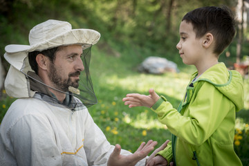 Father beekeeper and son talking