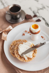 Light breakfast with egg and coffee