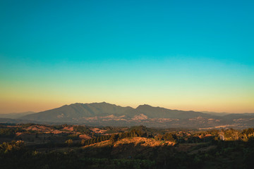 Naklejka premium Mountains Clouds, Blue Orange Sky Gradient