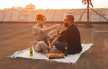 Couple having romantic picnic on rooftop