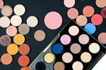 Make-up colorful eye shadow palettes isolated on black background. 