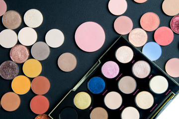 Make-up colorful eye shadow palettes isolated on black background. 
