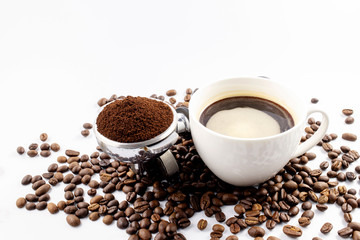 Coffee cop and brown roasted coffee beans and coffee powder on the potta filter isolated on white background.