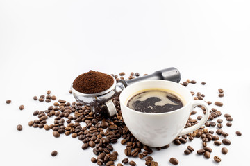 Coffee cop and brown roasted coffee beans and coffee powder on the potta filter isolated on white background.