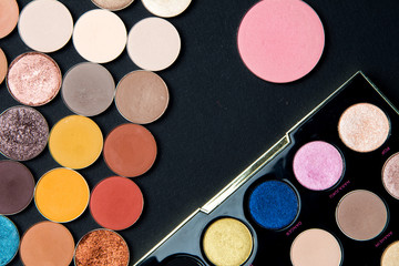 Make-up colorful eye shadow palettes isolated on black background. 