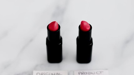 beauty industry, two identhical looking lipsticks with Original Product and Product Dupe labels and camera panning vertically