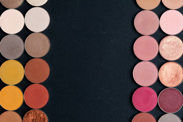 Make-up colorful eye shadow palettes isolated on black background.