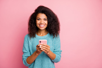 Photo of cheerful toothy beaming cute nice pretty woman holding telephone browsing social media working as smm manager isolated pastel color background