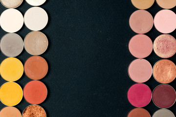 Make-up colorful eye shadow palettes isolated on black background.