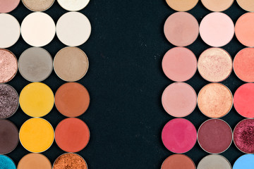 Make-up colorful eye shadow palettes isolated on black background.