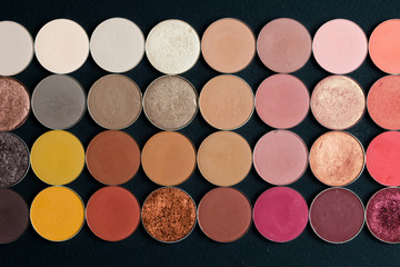Make-up colorful eye shadow palettes isolated on black background.