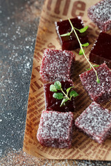 Homemade  multicolored marmalade candy in sugar on dark background. Fruit jelly candies. Fruit chewy candy. Jelly Bean. Assortment of colorful fruit jelly candy. Copy space