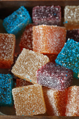 Homemade  multicolored marmalade candy in sugar on dark background. Fruit jelly candies. Fruit chewy candy. Jelly Bean. Assortment of colorful fruit jelly candy. Copy space