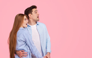 Amazed couple looking away together