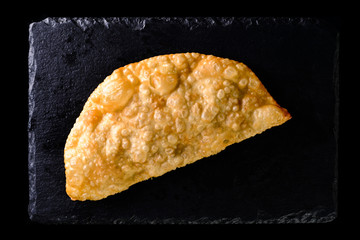 cheburek on a black background