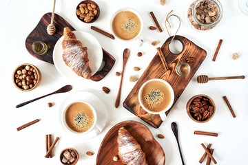 breakfast pattern, croissant, coffee, honey, cinnamon sticks, nuts, sugar. Good morning concept.