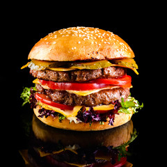 Homemade double cheese burger Black background