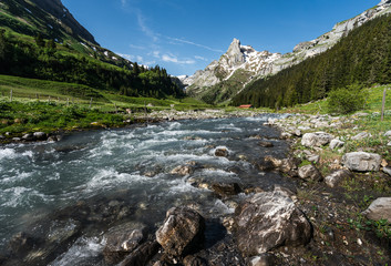 Naklejka na ściany i meble Alpine river in the Swiss Alps